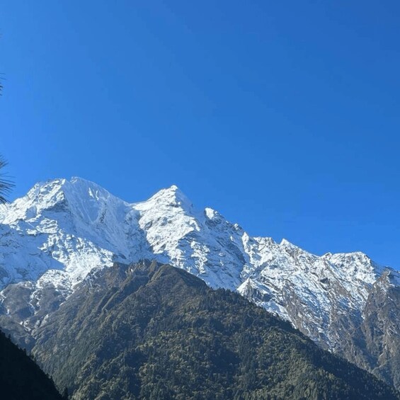 A snow-covered mountain peak under a clear blue sky. 2