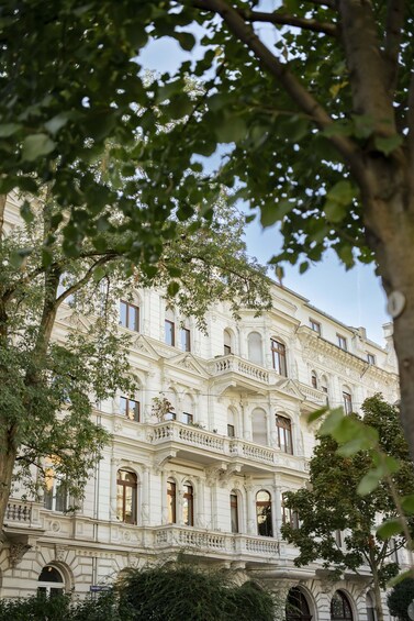 A historic building with ornate architecture, surrounded by trees. 1
