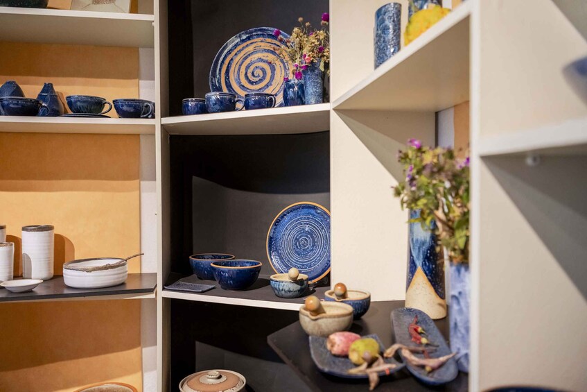 A display of various ceramic bowls and plates on shelves. 4