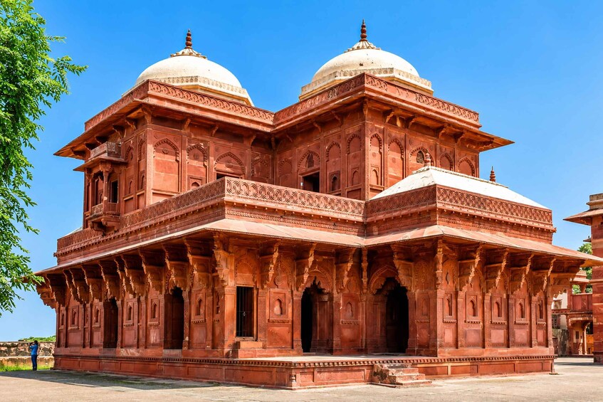 A large, ornate building with two domes and intricate carvings. 5