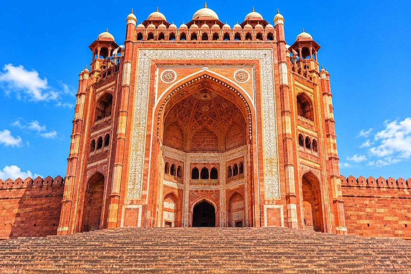 A large, ornate building with multiple domes and intricate carvings. 1
