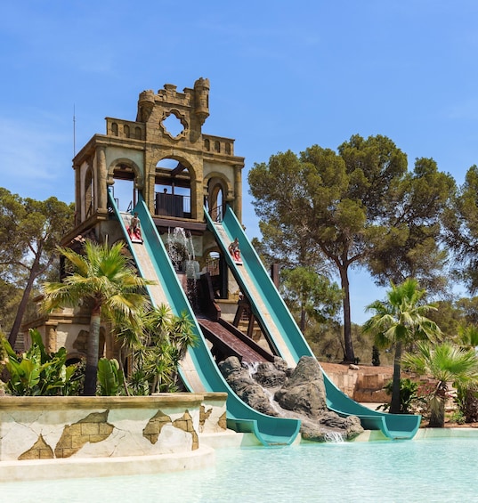 A water slide with a castle-like structure in the background. 3