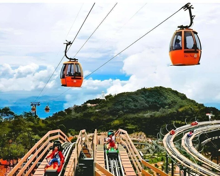 A cable car system, a wooden roller coaster, and a mountainous landscape. 2