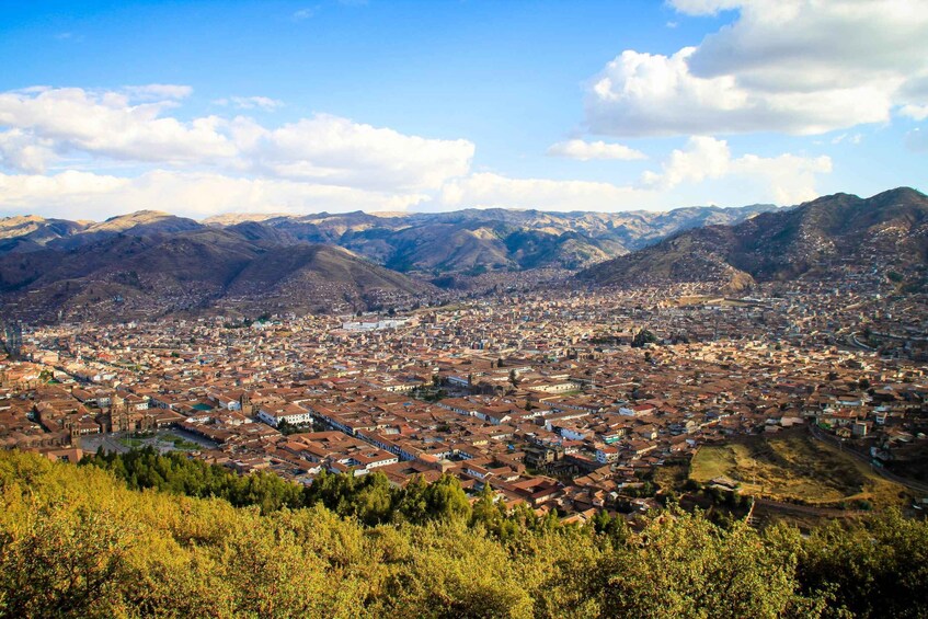 A city nestled in a valley surrounded by mountains. 4