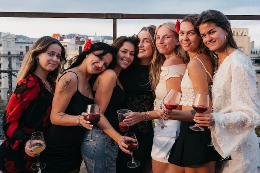 A group of people standing together, holding wine glasses. 3
