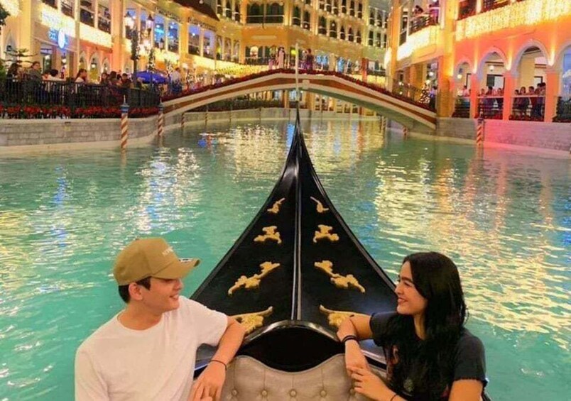 A gondola ride in an indoor water park with a bridge in the background. 5