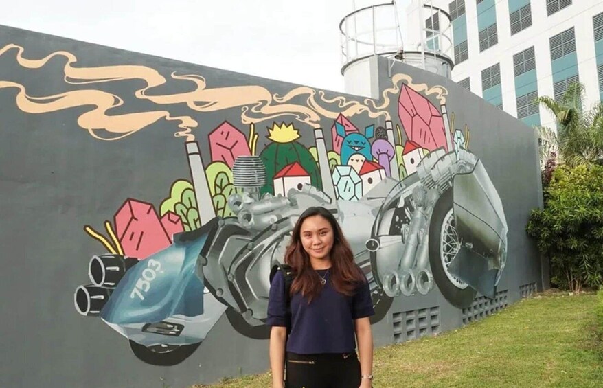 A mural with a car and buildings. 2