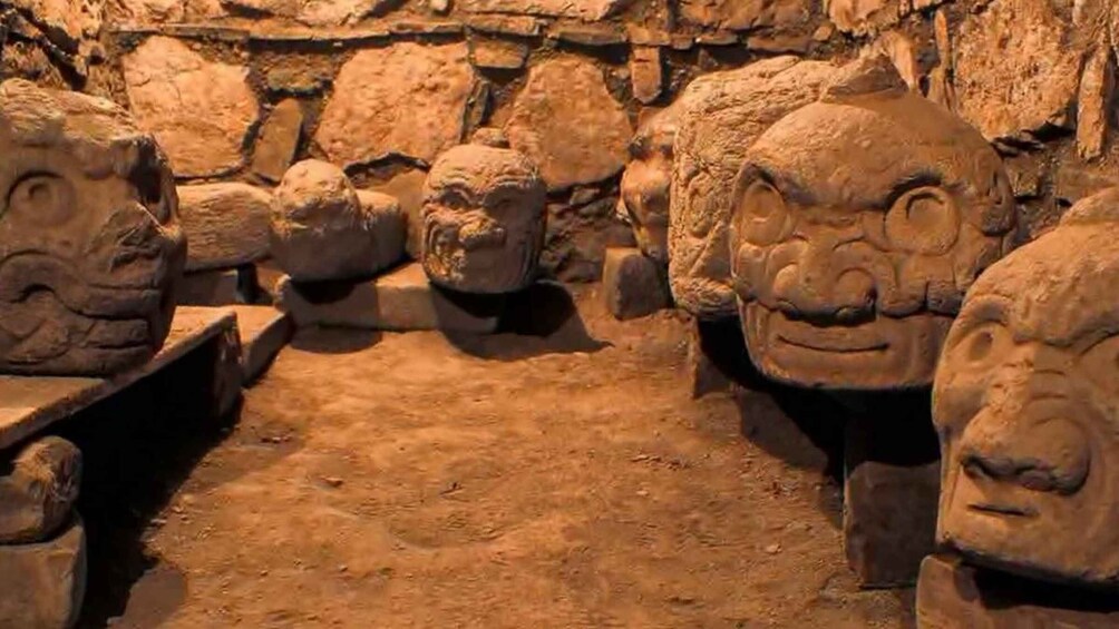 A collection of ancient stone carvings in a cave. 5
