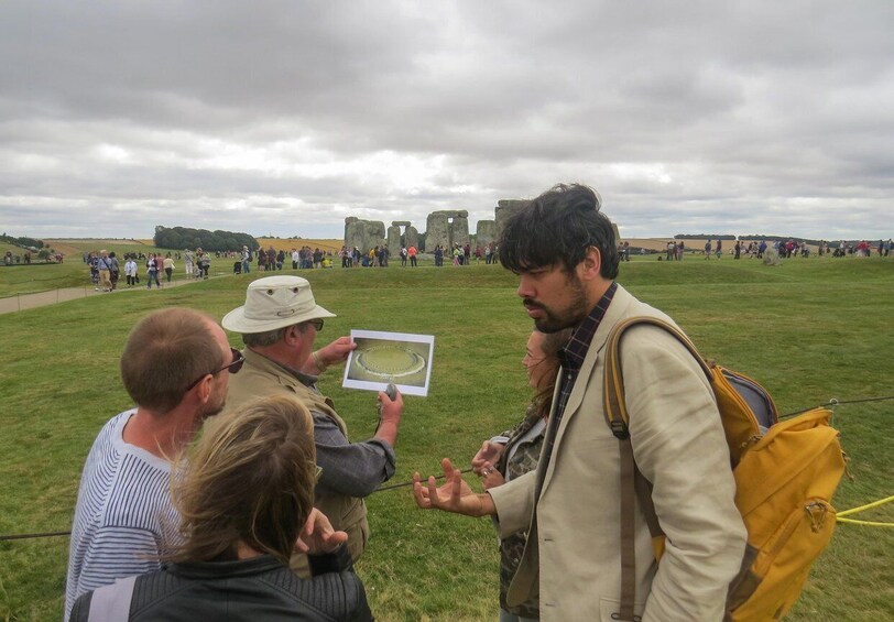 A group of people at Stonehenge, a historic stone circle monument. 5