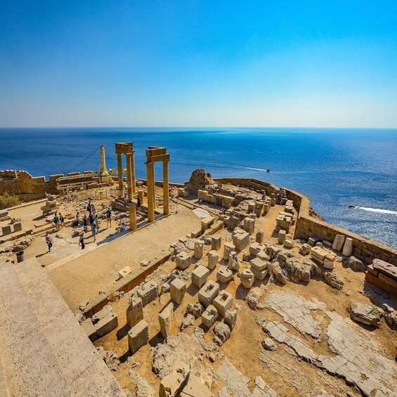 Ancient ruins with columns and stone blocks near the sea. 5