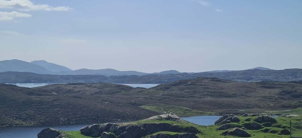 A mountainous landscape with a lake and rocky terrain. 4