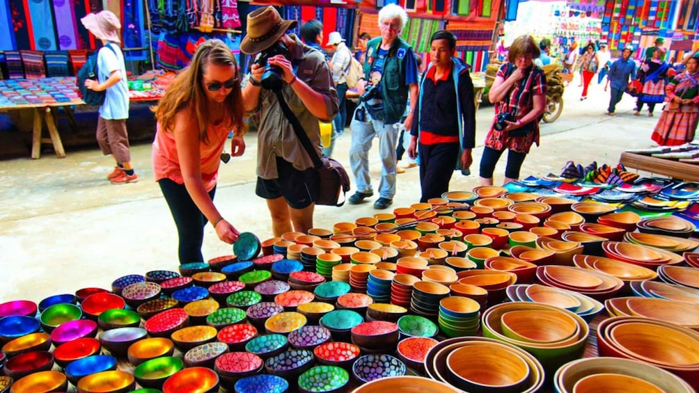 A market stall with colorful bowls and plates. 5