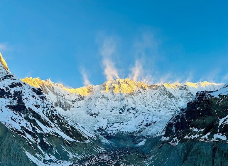 A snow-covered mountain range with a clear sky. 1