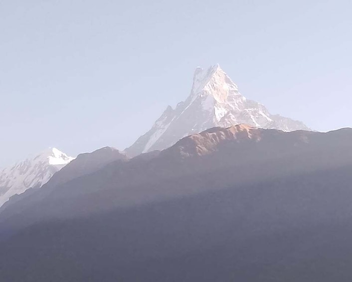 A snow-capped mountain peak with a clear sky. 2