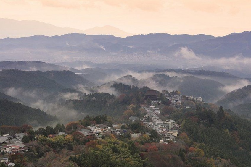 A mountainous landscape with a village nestled in the valley. 2