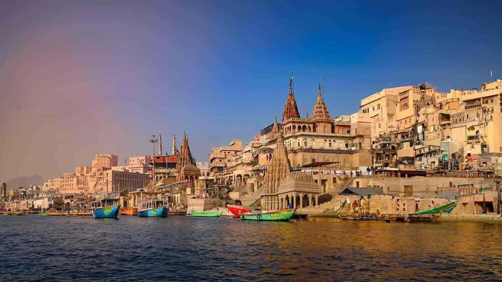 A riverside cityscape with historic architecture and boats along the water. 5