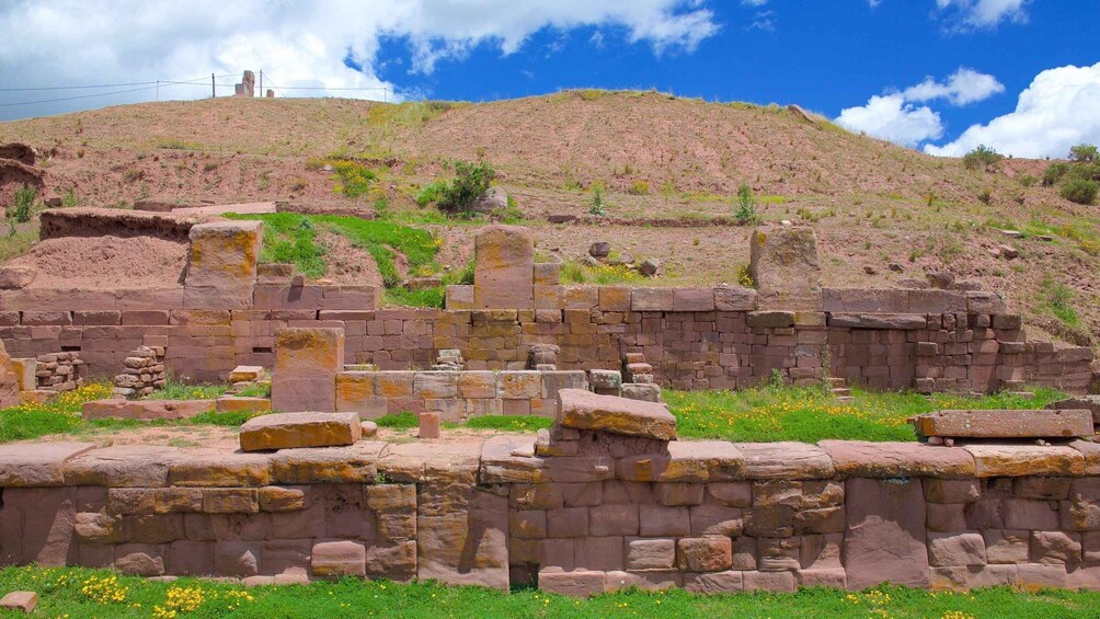 Ancient stone ruins on a hillside with a clear sky. 2