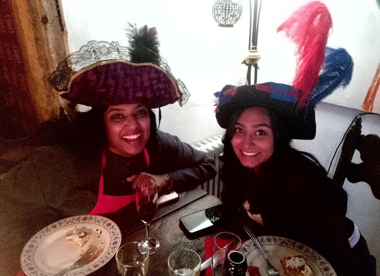 Two people at a table with plates, glasses, and a smartphone. 4