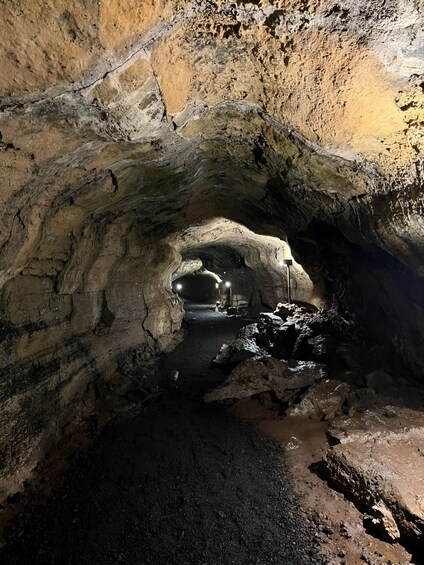 A cave with a water pool and rocky formations. 2