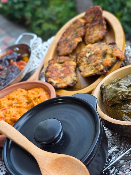 A variety of dishes including a pot of stew, a bowl of rice, and a dish with meat and vegetables. 1