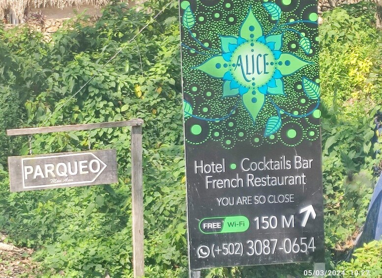 A sign for a hotel, cocktails bar, and French restaurant named 'Alice' with a decorative design. 5