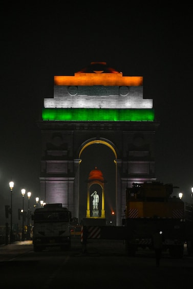 The India Gate at night with illuminated Indian flag colors. 4