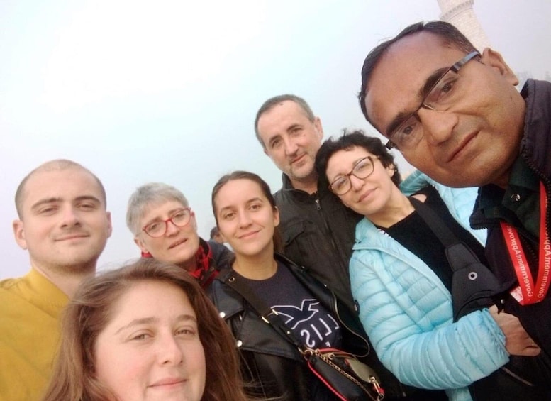 A group of people outdoors, some wearing jackets, suggesting a cool climate. 4