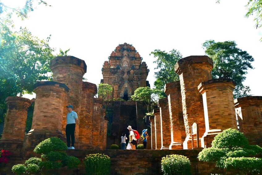 Ancient brick structures with tourists exploring. 1