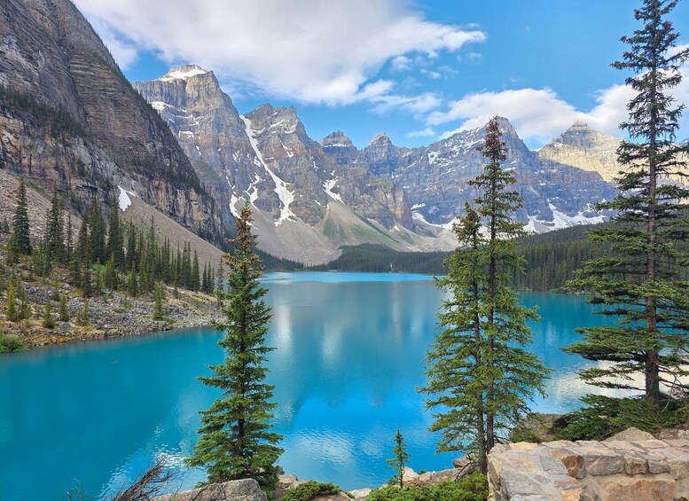 A mountain lake surrounded by rugged mountains and coniferous trees. 1