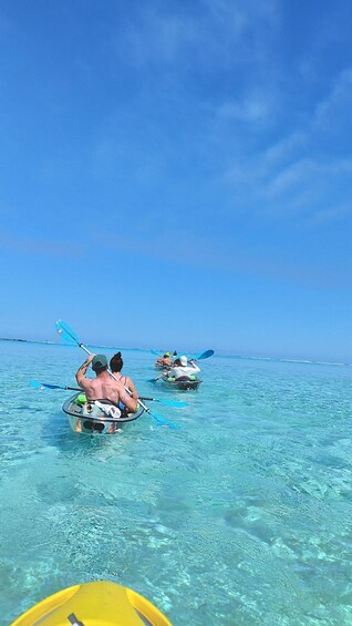 People kayaking on clear blue water. 2