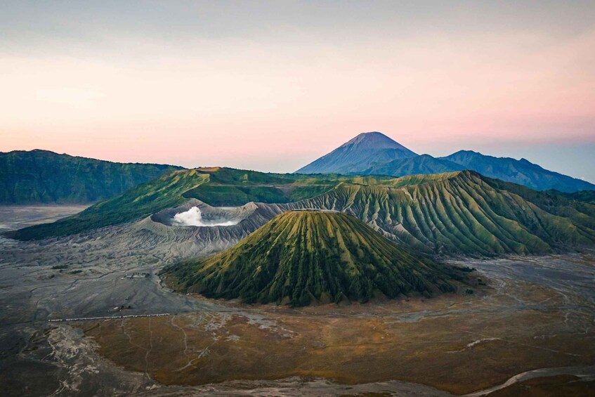 A volcanic landscape with distinct ridges and a prominent mountain in the background. 1