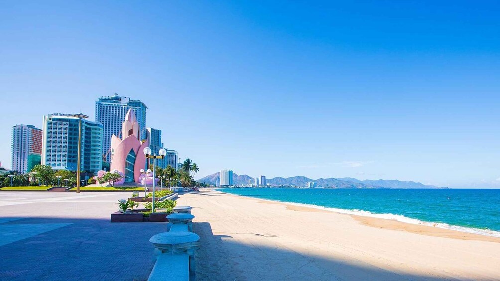 A beach with a cityscape in the background. 4