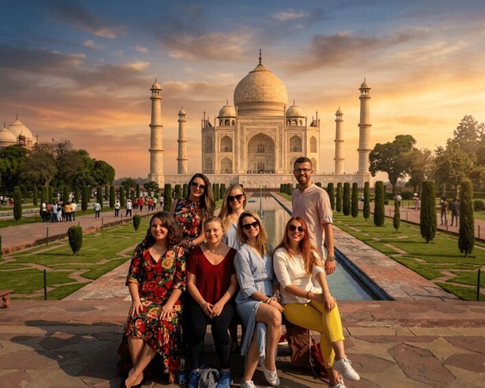 En grupp människor framför Taj Mahal, med dess välkända kupoler och minareter. 3