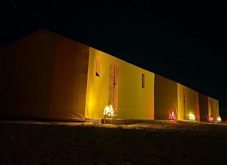 A large, illuminated tent-like structure at night. 4