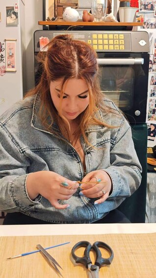 A person sewing with a needle and thread. 5