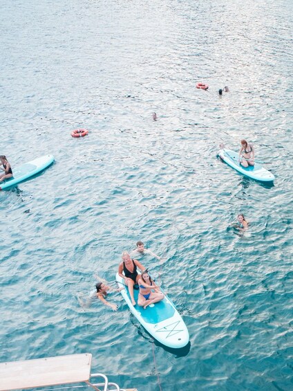People on paddleboards in a body of water. 4