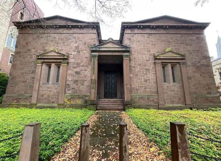 A historic brick building with a central entrance and two smaller doors on either side. 2