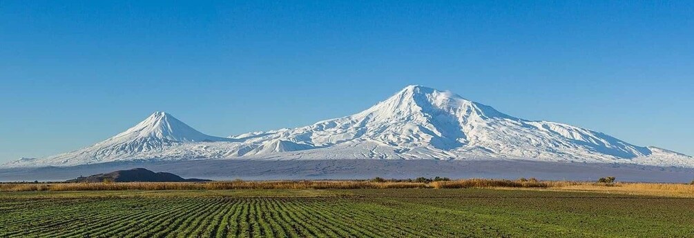 A snow-capped mountain with a clear sky. 5
