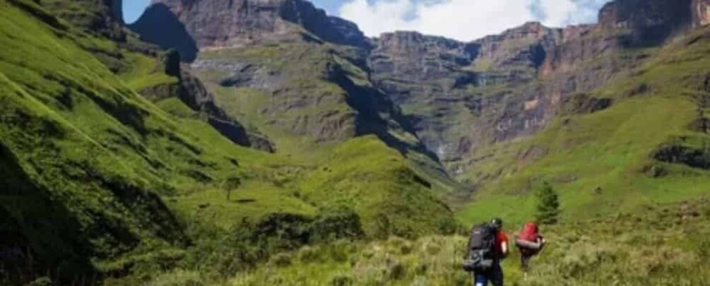 A hiker with a backpack in a mountainous valley. 3