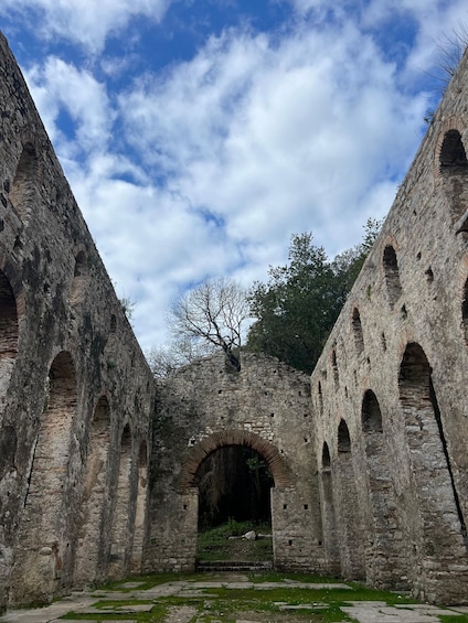 An ancient stone structure with arched passageways and a central archway. 3