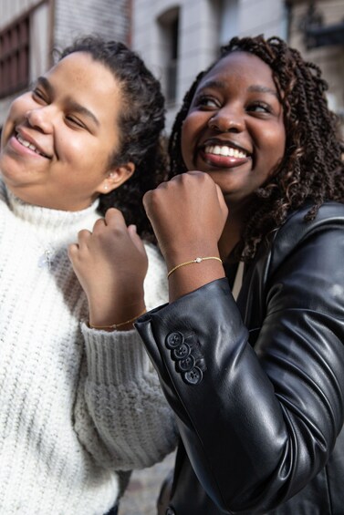 Two people wearing a white sweater and a black leather jacket. 1