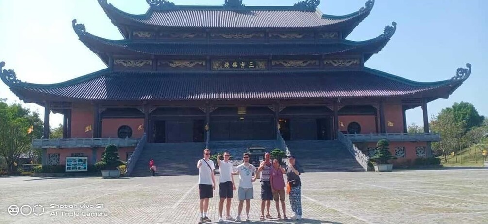 A traditional Chinese building with a multi-tiered roof and a staircase leading up to the entrance. 1
