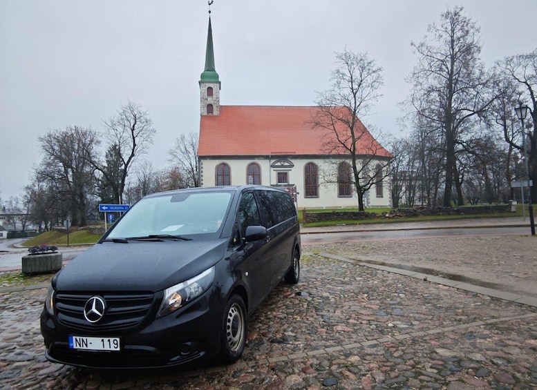 A black Mercedes-Benz SUV parked on a cobblestone street. 3