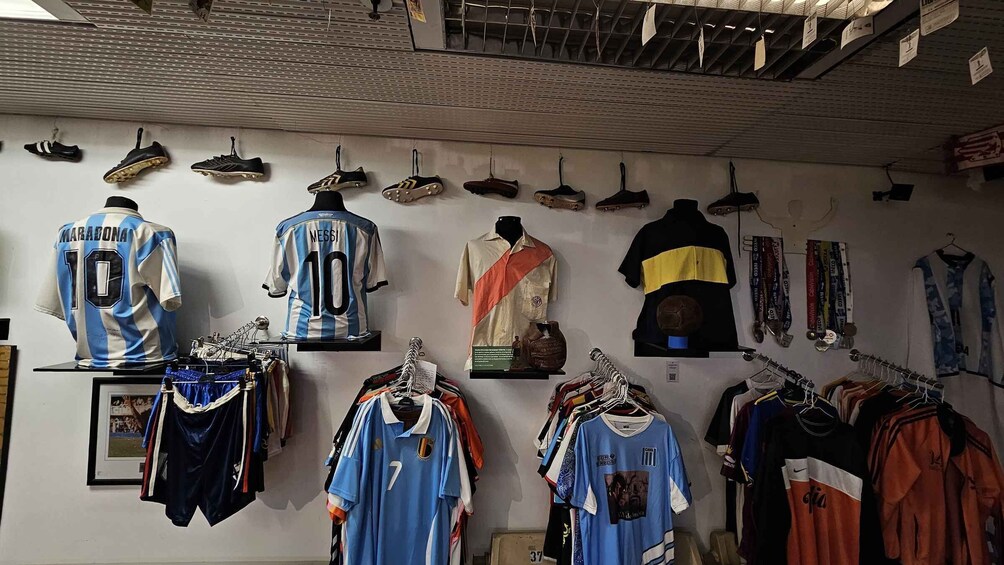 A sports memorabilia shop with jerseys, shoes, and other items displayed on the wall and racks. 3
