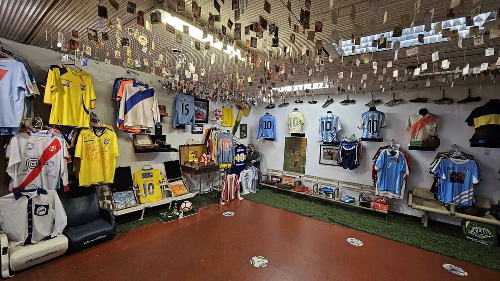 A sports memorabilia shop with jerseys, shoes, and various sports items displayed on shelves and walls. 1