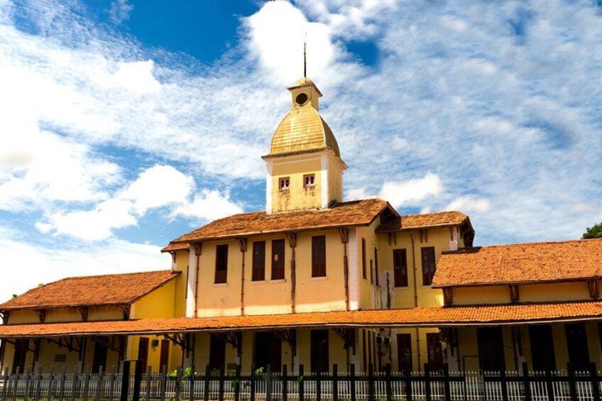A historic building with a prominent tower and a tiled roof. 3