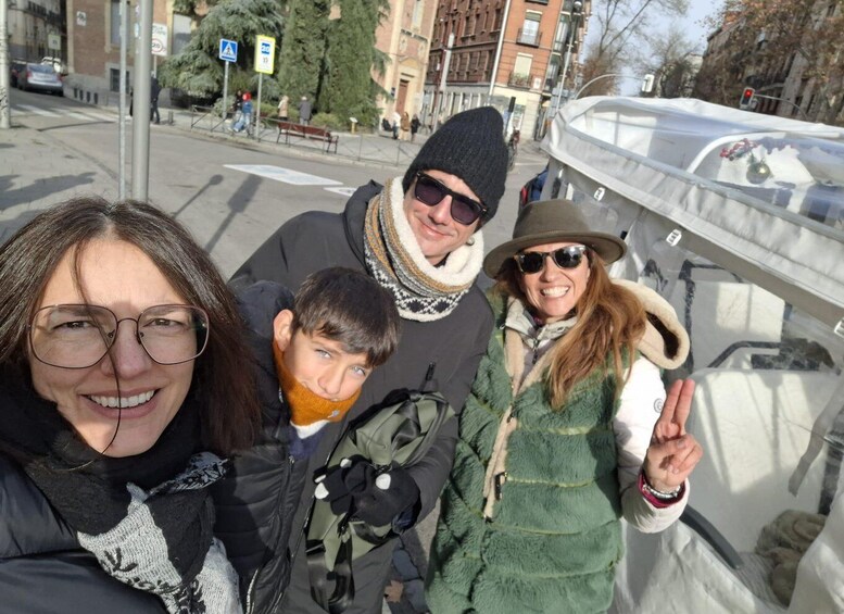 A group of people on a bridge with buildings and trees in the background. 4