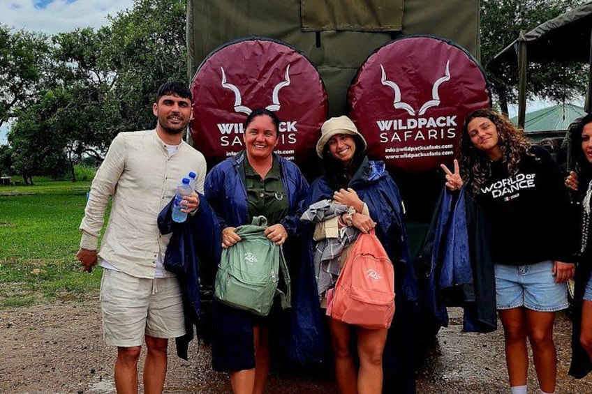 A group of people standing in front of a vehicle with 'WILDPACK SAFARIS' branding. 2