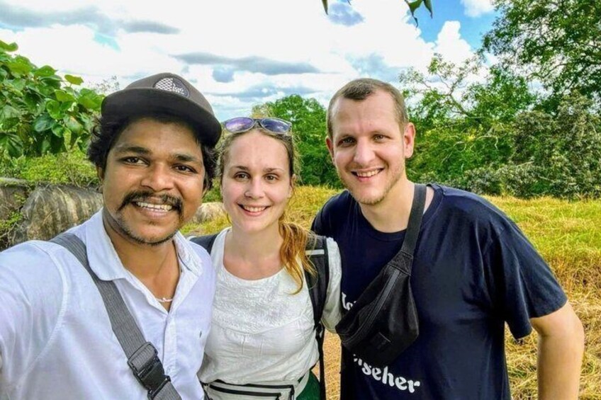 Three people outdoors with greenery in the background. 2