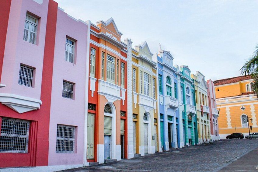 A row of colorful buildings with a cobblestone street. 2